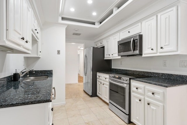 kitchen with white cabinetry, sink, ornamental molding, and stainless steel appliances