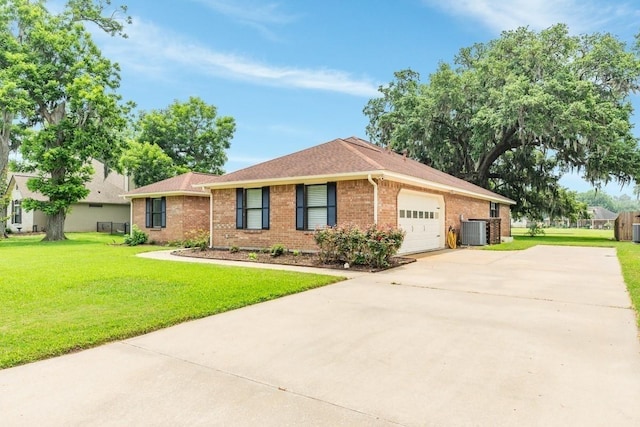 ranch-style house with central AC, a front lawn, and a garage