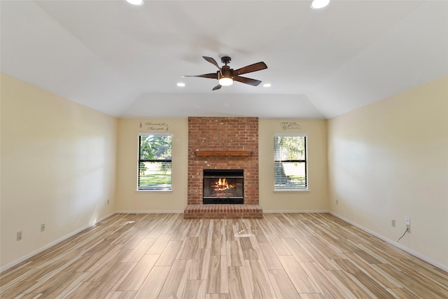 unfurnished living room with ceiling fan, light wood-type flooring, and a fireplace