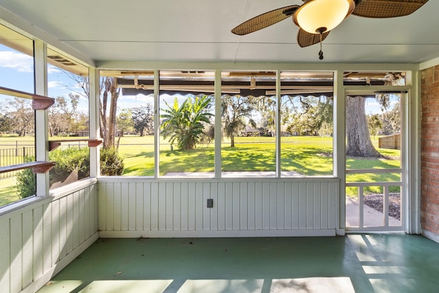 unfurnished sunroom with ceiling fan