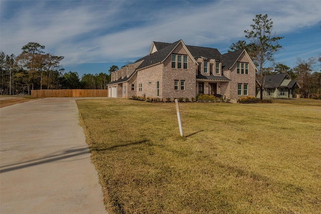 tudor house with a garage and a front yard