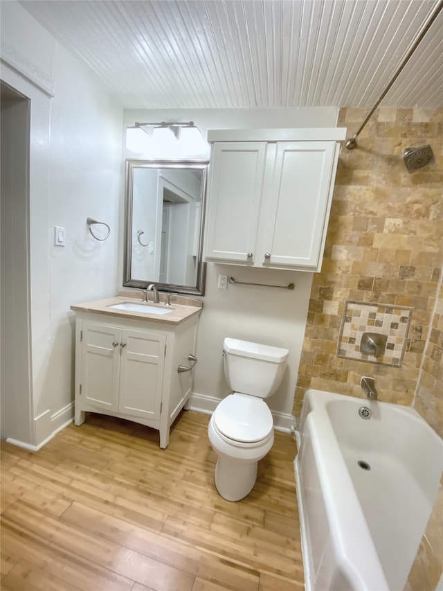 full bathroom with washtub / shower combination, wood-type flooring, toilet, and vanity