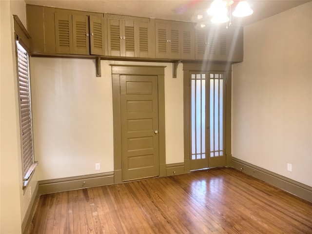 interior space with wood-type flooring and ceiling fan