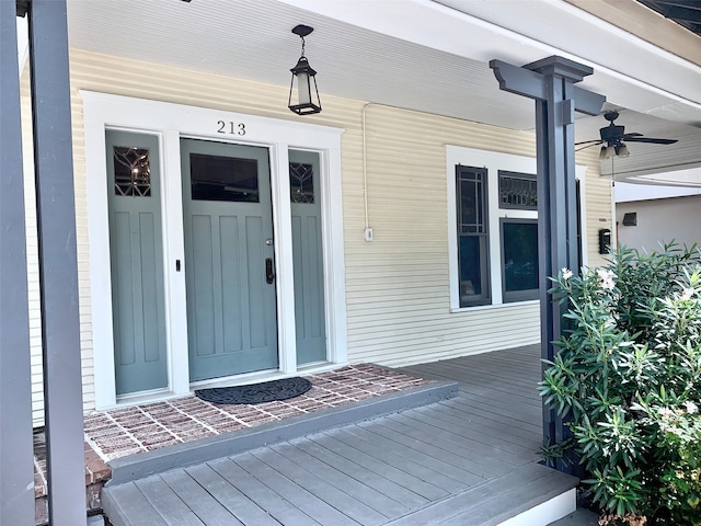 property entrance featuring covered porch and ceiling fan