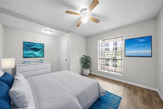 bedroom with ceiling fan and light hardwood / wood-style flooring