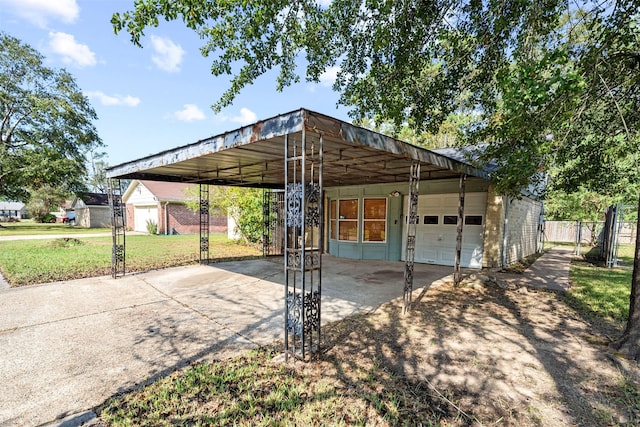 view of vehicle parking featuring a garage, a yard, and a carport