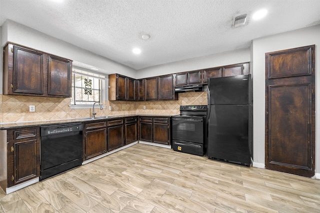 kitchen with black appliances, dark brown cabinets, decorative backsplash, sink, and light hardwood / wood-style floors