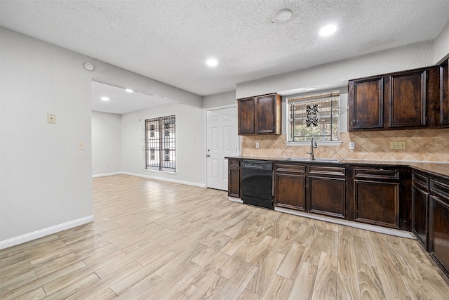 kitchen featuring dark brown cabinetry, sink, light wood-type flooring, and dishwasher