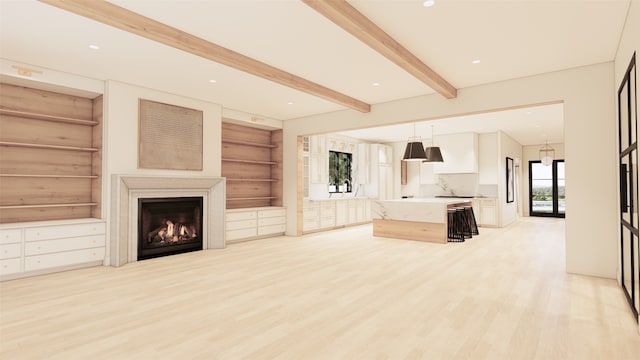 unfurnished living room with light hardwood / wood-style floors and beam ceiling