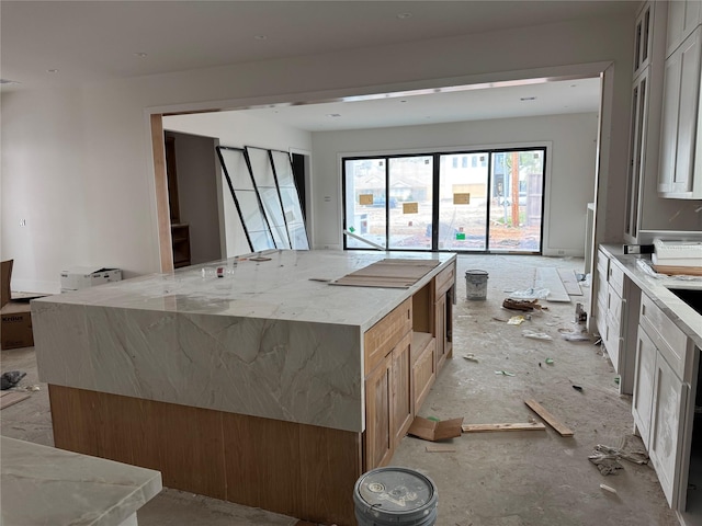 kitchen featuring light stone countertops and a spacious island