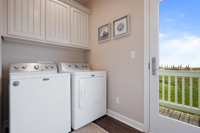 laundry area with cabinets, separate washer and dryer, and dark hardwood / wood-style floors