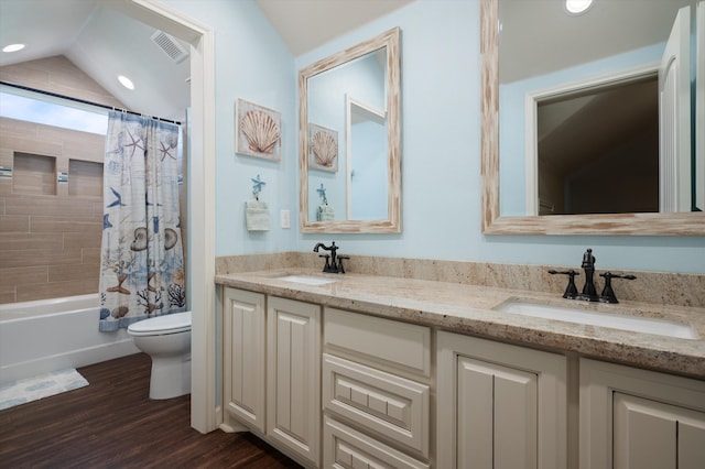 full bathroom with hardwood / wood-style floors, vanity, shower / bath combo, lofted ceiling, and toilet