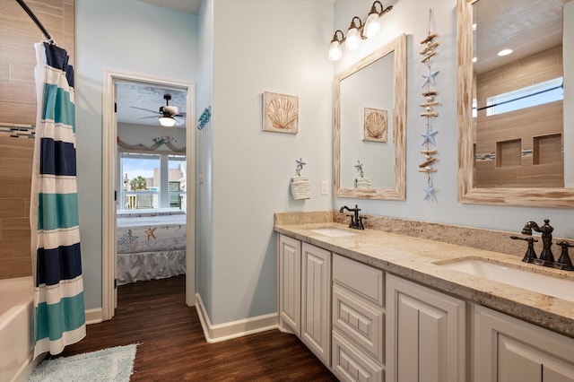 bathroom with shower / bath combo, hardwood / wood-style floors, a wealth of natural light, and vanity