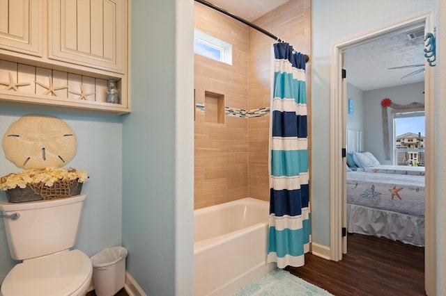 bathroom featuring shower / bath combo, wood-type flooring, and toilet