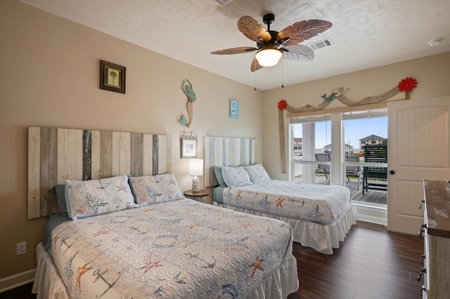 bedroom with ceiling fan, a textured ceiling, access to exterior, and dark hardwood / wood-style flooring