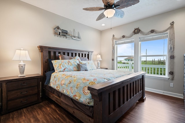 bedroom featuring dark hardwood / wood-style flooring and ceiling fan