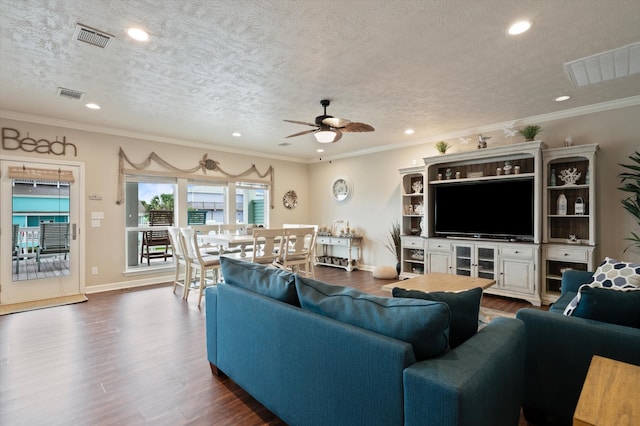 living room with dark wood-type flooring, ceiling fan, a textured ceiling, and crown molding