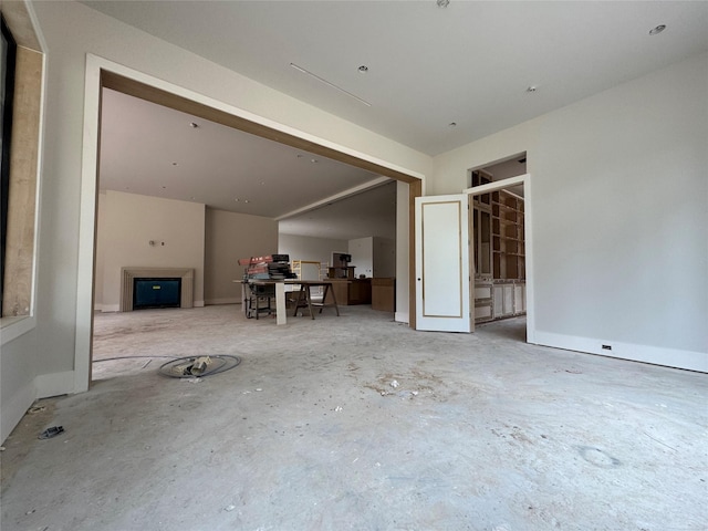 710 Glen Echo Ln, Hedwig Village, TX 77024 - unfurnished living room with concrete flooring and a desk