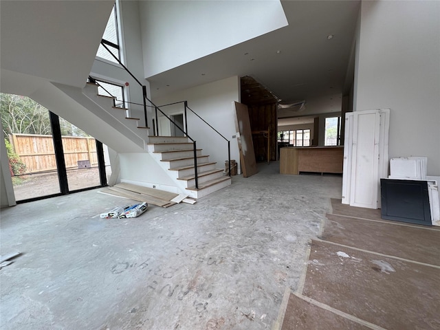 710 Glen Echo Ln, Hedwig Village, TX 77024 - unfurnished living room with a high ceiling and stairway