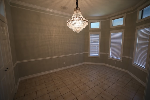 empty room with light tile patterned flooring, crown molding, and an inviting chandelier