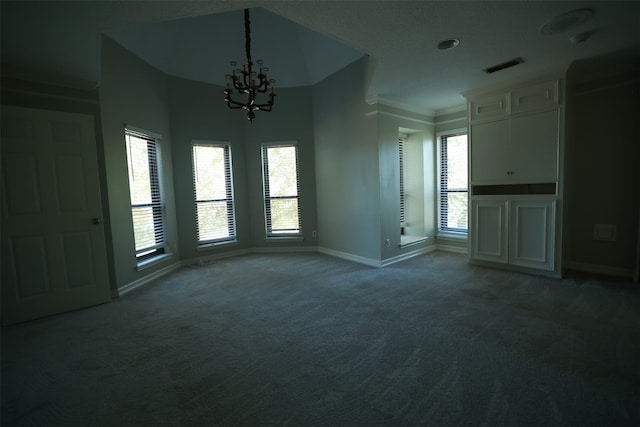 interior space with plenty of natural light, a notable chandelier, crown molding, and dark carpet