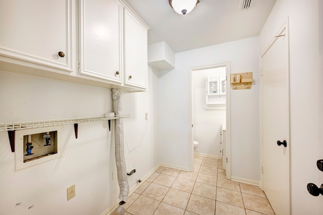 laundry room featuring hookup for a washing machine, cabinets, and light tile patterned flooring