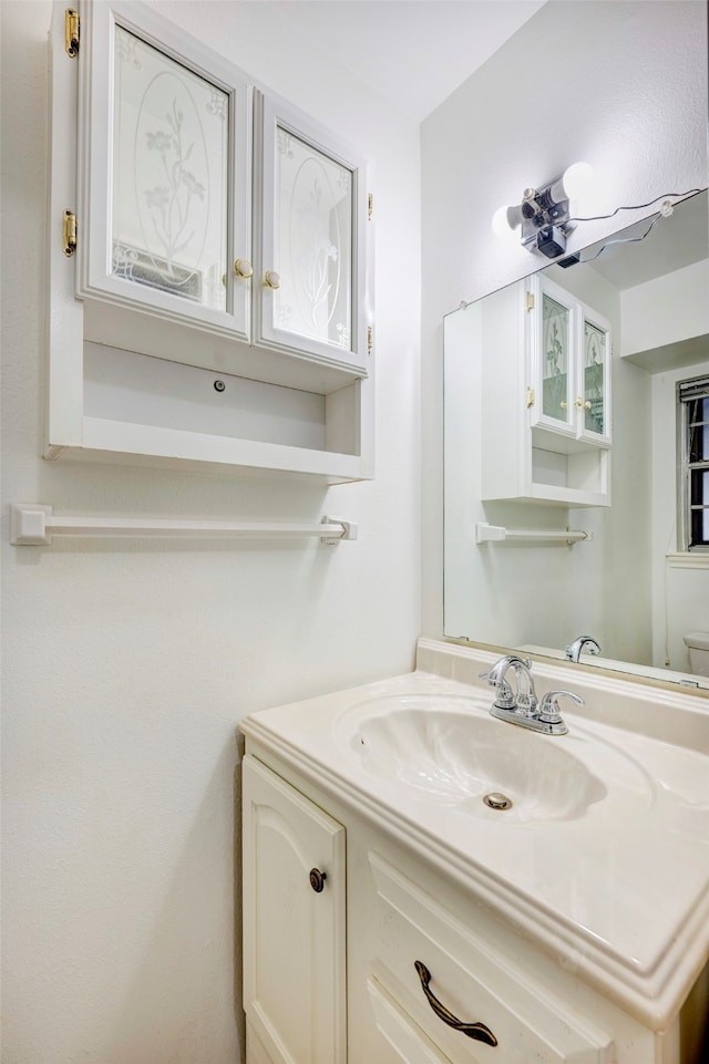 bathroom with vanity and toilet