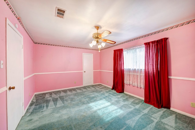 carpeted spare room with ceiling fan