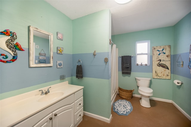 bathroom with toilet, vanity, and curtained shower