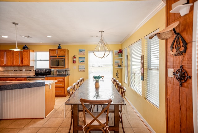 tiled dining room with ornamental molding