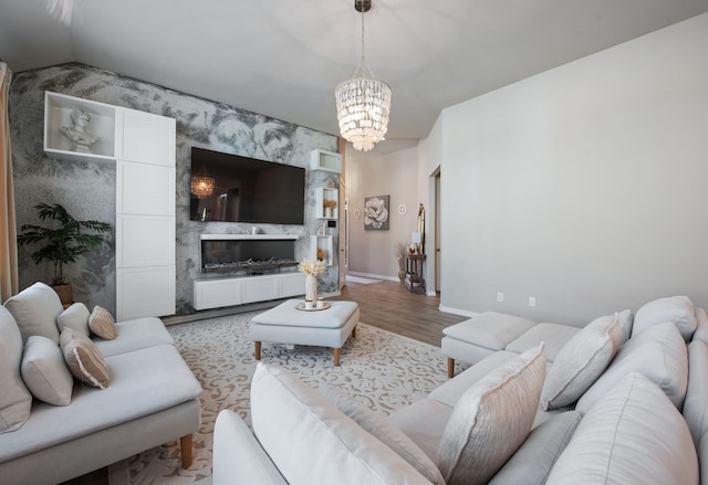 living room featuring lofted ceiling, hardwood / wood-style flooring, and a notable chandelier