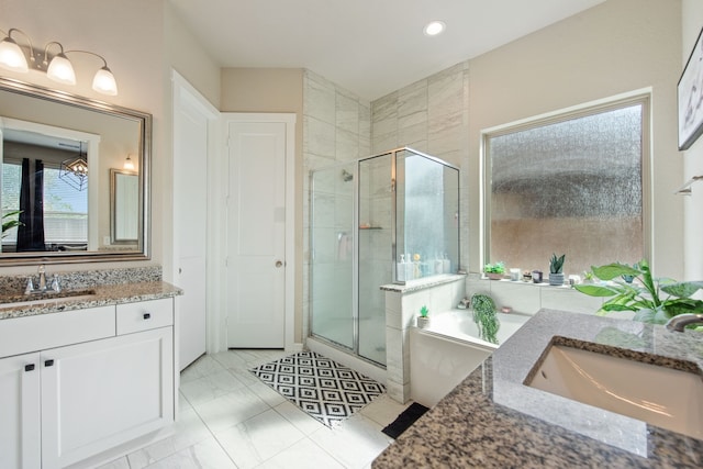 bathroom with vanity, shower with separate bathtub, and tile patterned flooring