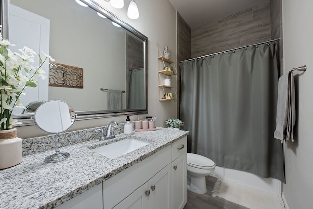 bathroom featuring toilet, vanity, and hardwood / wood-style floors