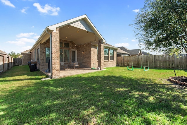 back of house featuring a yard and a patio area