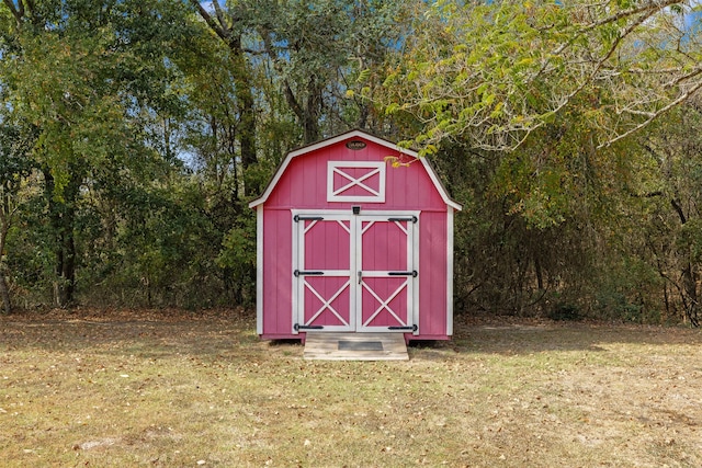 view of outbuilding with a lawn