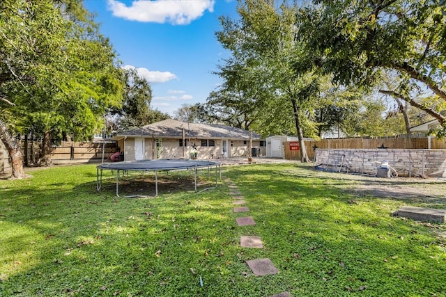 view of yard with a shed and a trampoline