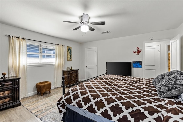 bedroom with ceiling fan and light hardwood / wood-style flooring