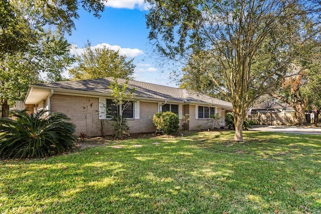 ranch-style home featuring a front yard