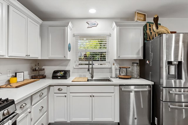 kitchen with white cabinetry, sink, and appliances with stainless steel finishes