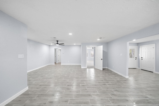 unfurnished living room with a wealth of natural light and ceiling fan