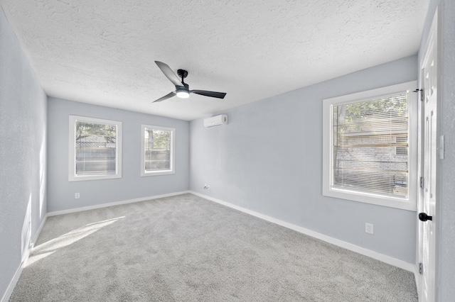 carpeted empty room featuring a textured ceiling and ceiling fan