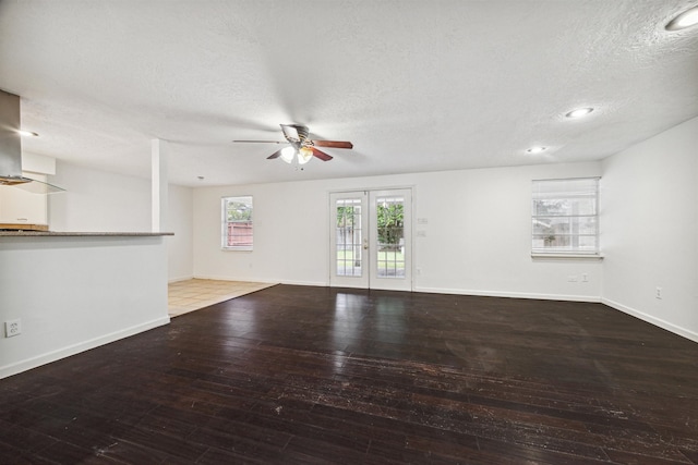 unfurnished living room featuring a textured ceiling and hardwood / wood-style flooring