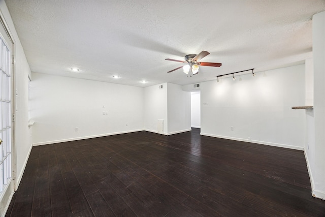 unfurnished room with dark wood-type flooring, a textured ceiling, and ceiling fan