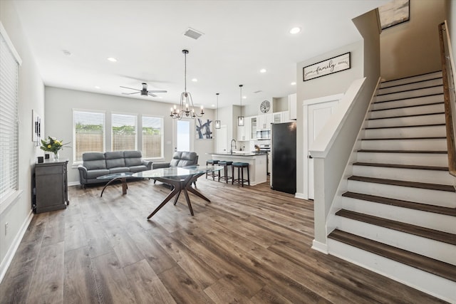 living room with ceiling fan, sink, and dark hardwood / wood-style floors