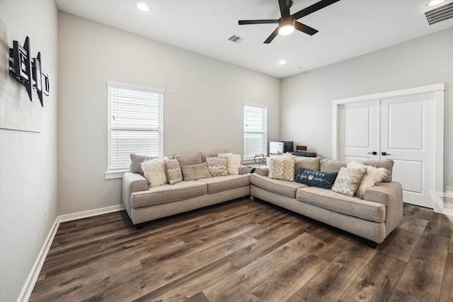 living room featuring ceiling fan and dark hardwood / wood-style flooring