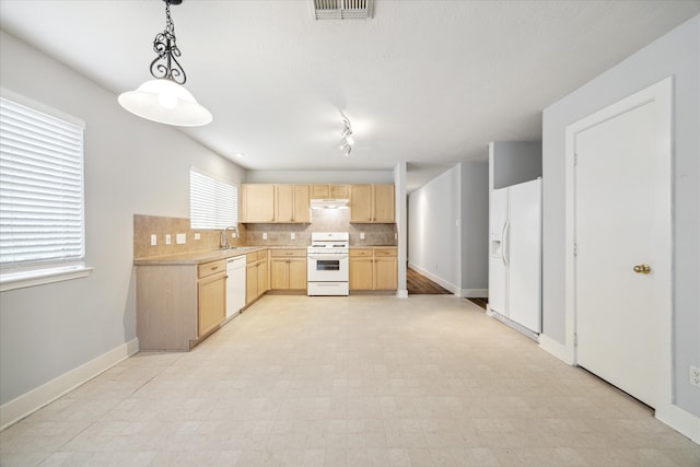 kitchen with pendant lighting, sink, backsplash, light brown cabinets, and white appliances