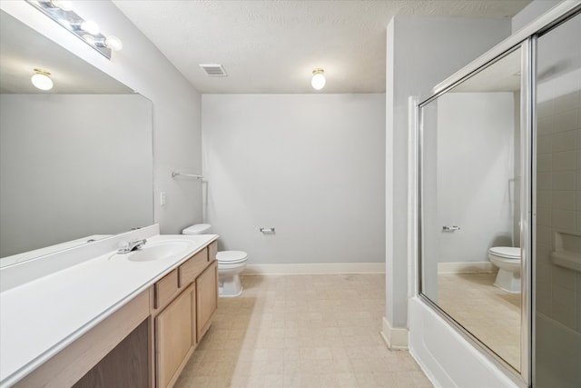 full bathroom with enclosed tub / shower combo, vanity, toilet, and a textured ceiling