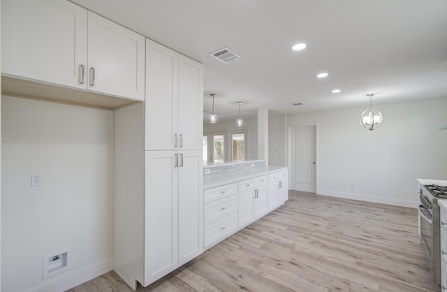 kitchen with pendant lighting and light hardwood / wood-style floors