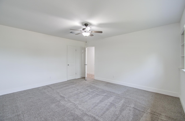 carpeted spare room with ceiling fan