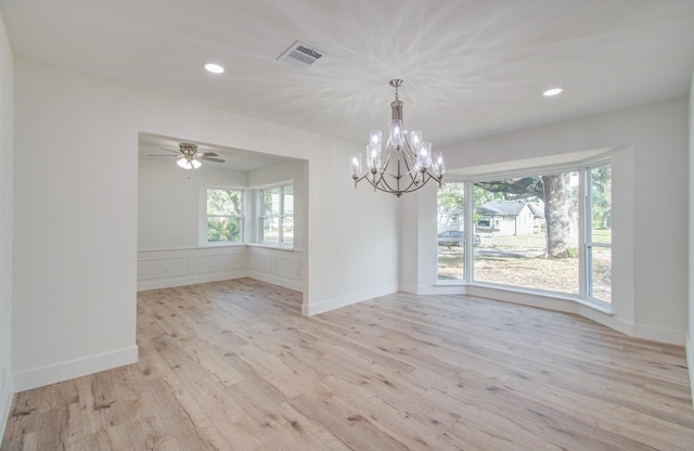 empty room with light hardwood / wood-style floors and ceiling fan with notable chandelier